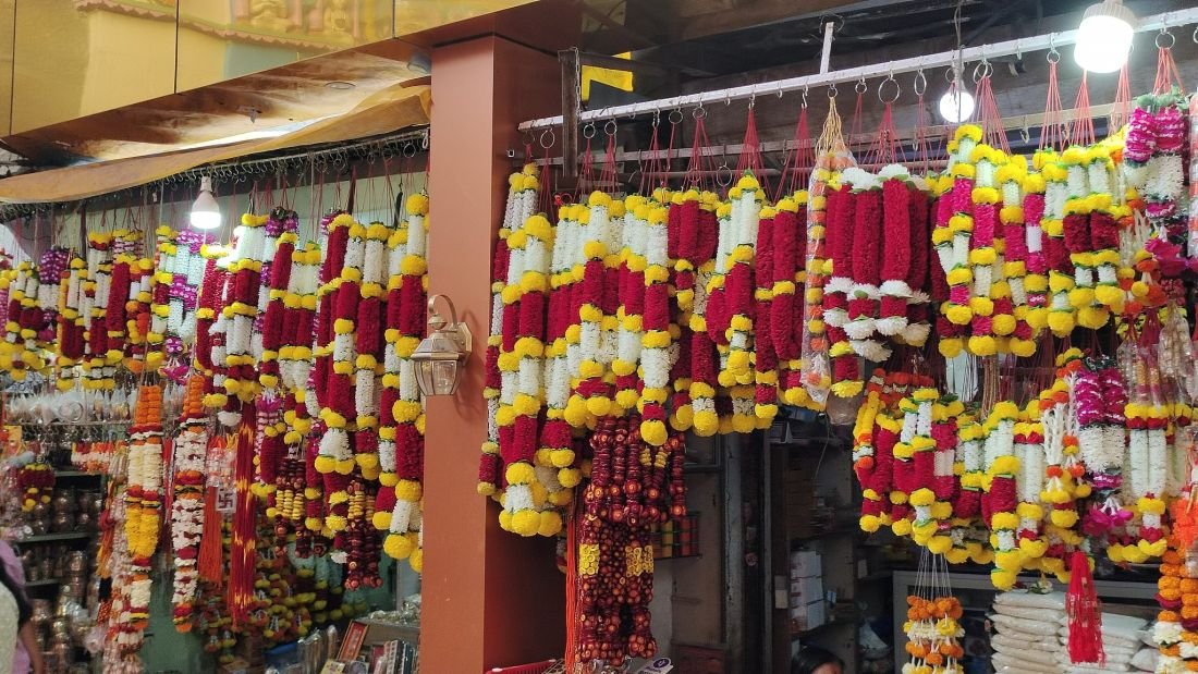 Fresh flower garlands hanging in a mala shop